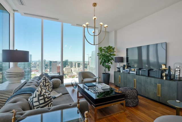 living room featuring a wall of windows, wood-type flooring, and a notable chandelier