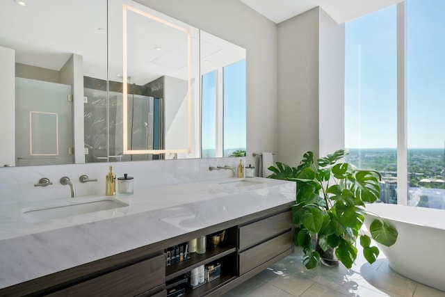 bathroom featuring tile patterned floors, a bathtub, and vanity