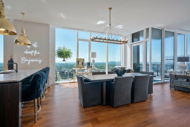 interior space featuring floor to ceiling windows, sink, and wood-type flooring