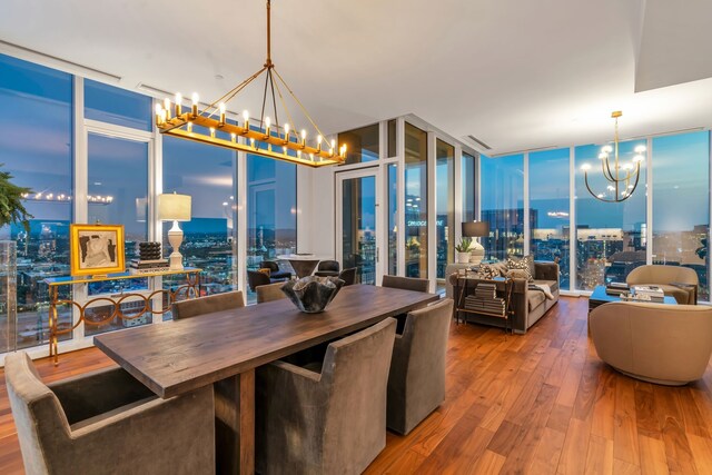 interior space with hardwood / wood-style flooring, pendant lighting, and a wall of windows