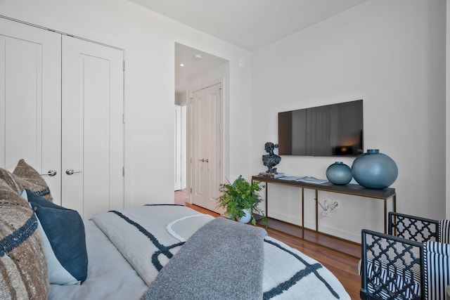 bedroom with a closet and dark wood-type flooring