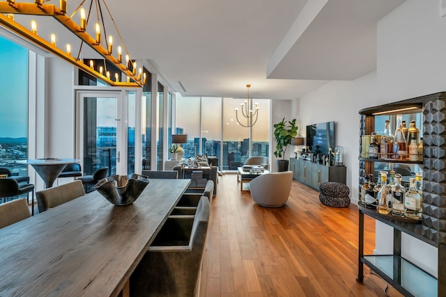 dining area featuring floor to ceiling windows and wood-type flooring