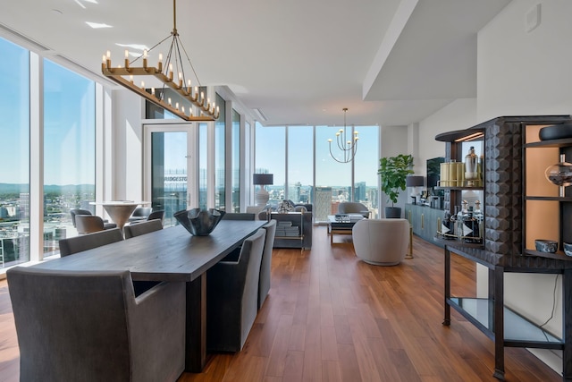 kitchen featuring hardwood / wood-style flooring, expansive windows, a healthy amount of sunlight, and pendant lighting