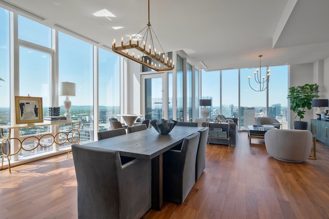 kitchen with hanging light fixtures, hardwood / wood-style floors, and expansive windows