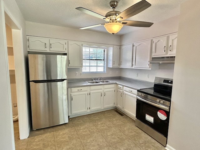 kitchen with appliances with stainless steel finishes, white cabinetry, ceiling fan, and sink