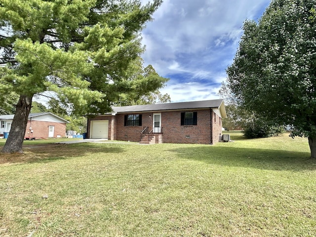 back of property featuring a yard and a garage