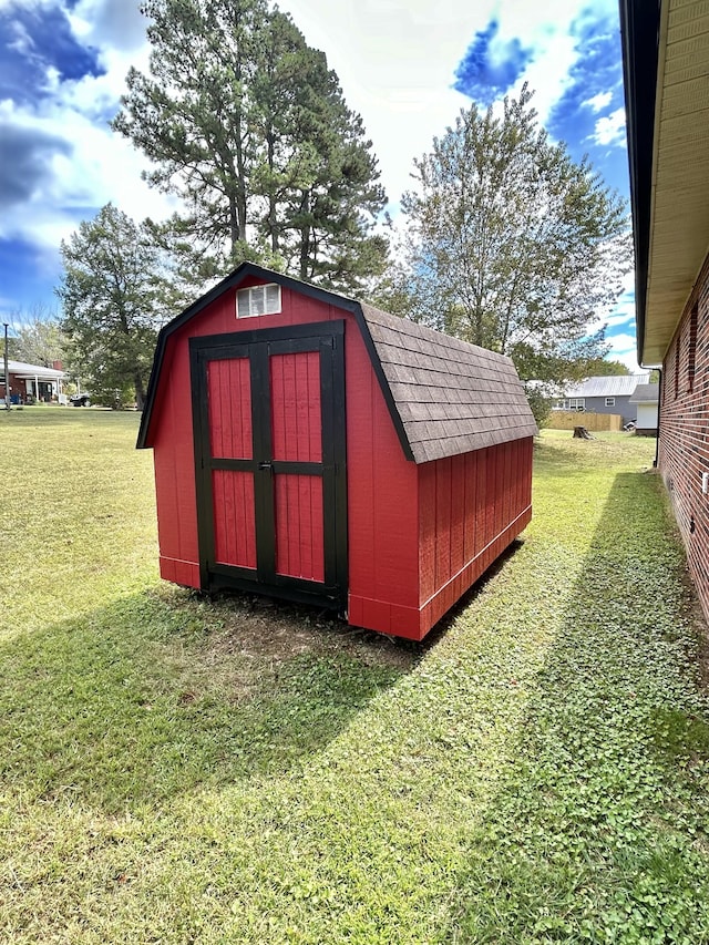 view of outbuilding featuring a yard