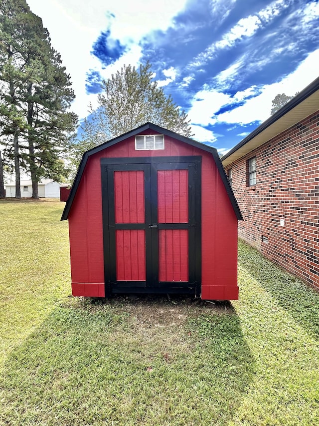 view of outdoor structure with a lawn