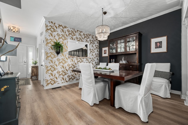 dining room featuring wood-type flooring and crown molding