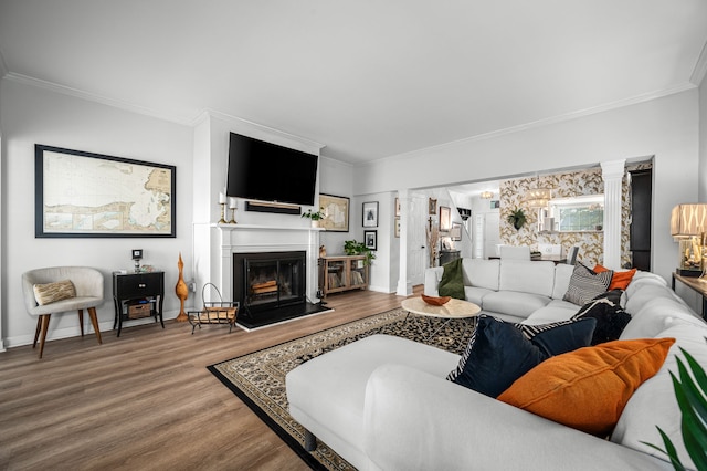 living room with hardwood / wood-style floors, ornate columns, and crown molding