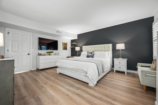 bedroom with hardwood / wood-style floors