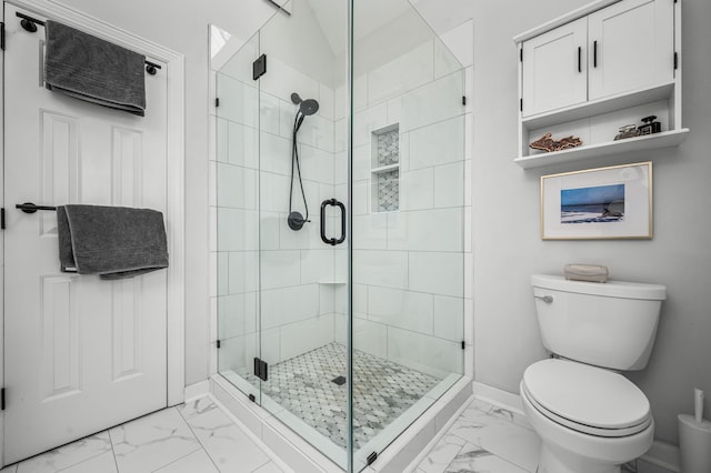 bathroom featuring an enclosed shower and toilet