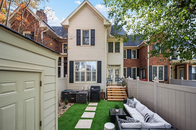 rear view of house featuring outdoor lounge area and a lawn