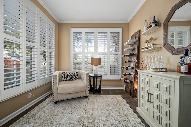 living area with bar area, dark tile patterned floors, and ornamental molding