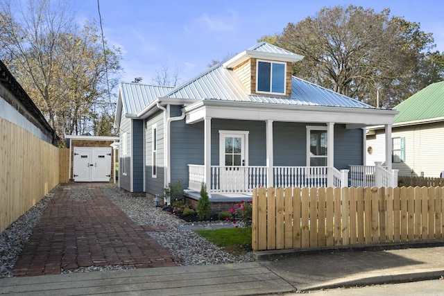 view of front of home featuring covered porch and a storage unit