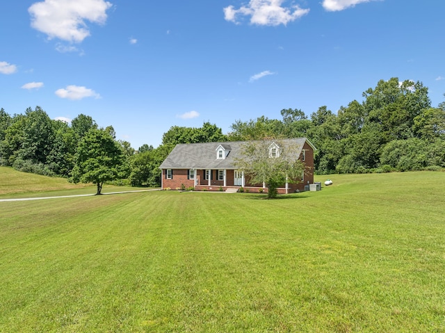 cape cod house with a front lawn