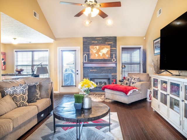 living room featuring a fireplace, dark hardwood / wood-style floors, high vaulted ceiling, and ceiling fan