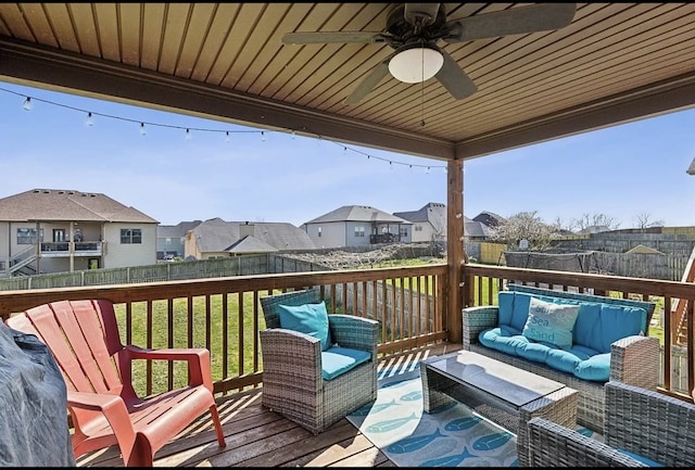 deck with an outdoor living space, ceiling fan, and a lawn