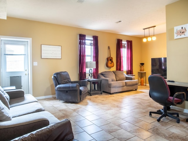 living room with plenty of natural light and light tile patterned floors