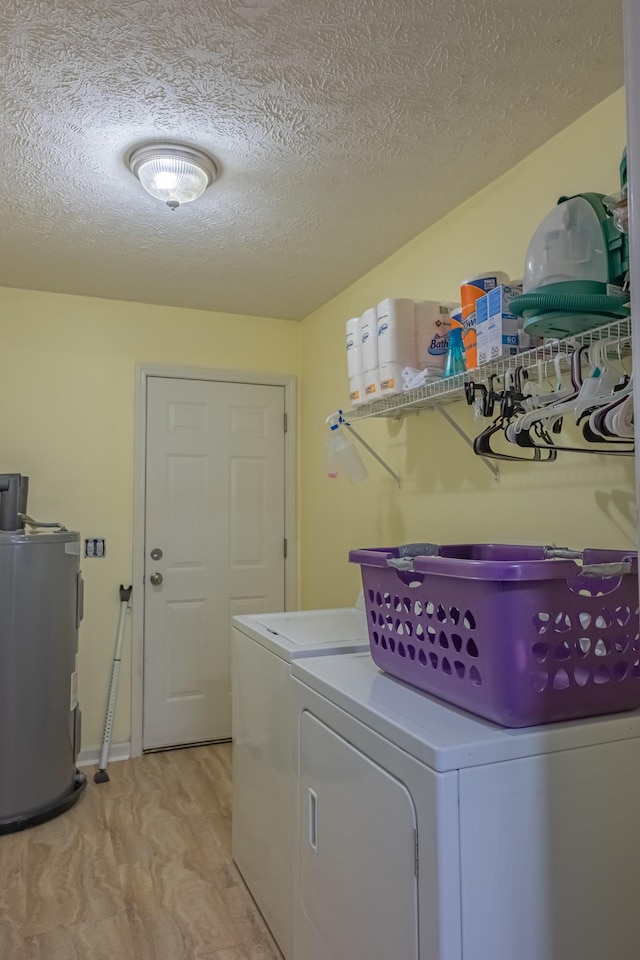 353 Oak Hollow Rd, Manchester, TN 37355 - laundry area featuring water heater, washer and clothes dryer, and a textured ceiling