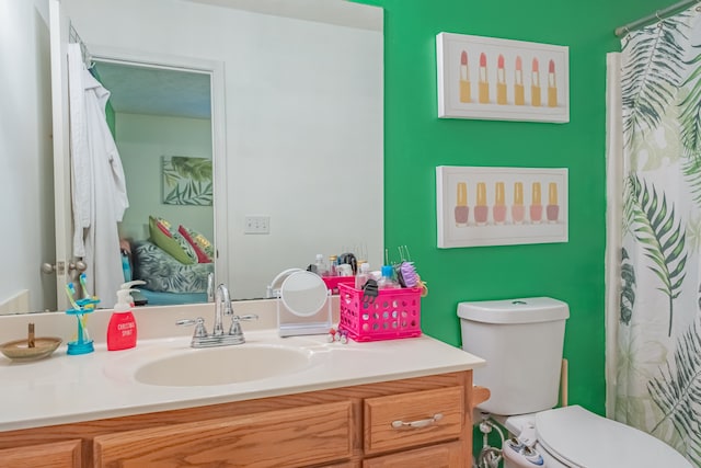 bathroom featuring vanity and toilet