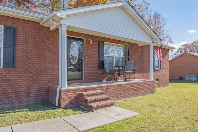 property entrance featuring a porch and a yard