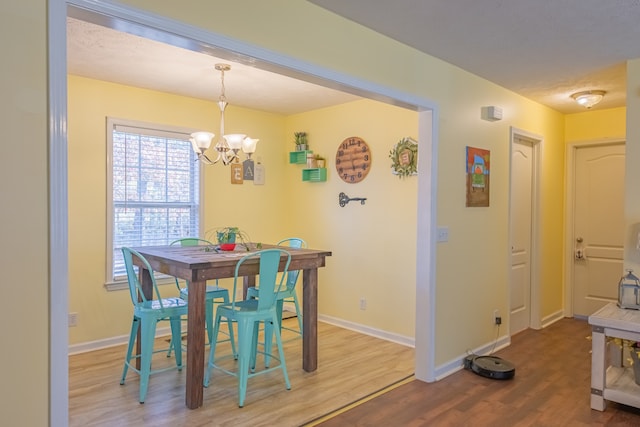 dining area with a chandelier and hardwood / wood-style floors