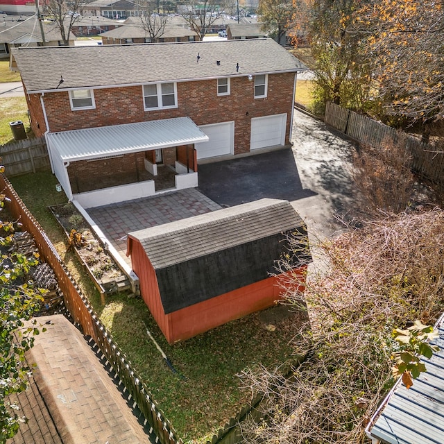 rear view of property featuring covered porch and a garage