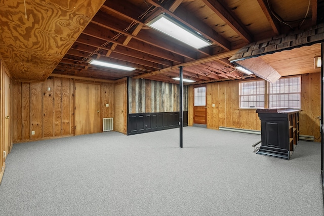 basement featuring carpet and a baseboard heating unit