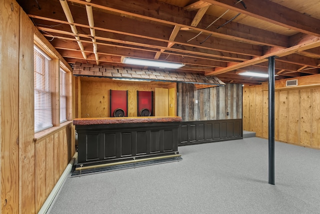 basement with carpet flooring and wooden walls