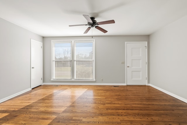 unfurnished room with ceiling fan and wood-type flooring