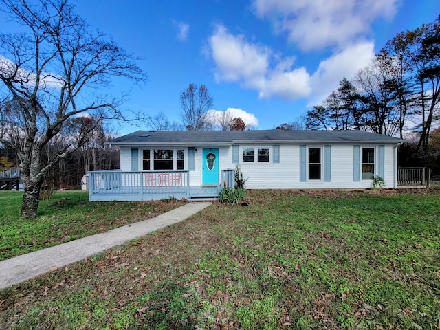 ranch-style house with a front yard and a deck