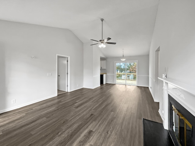 unfurnished living room featuring ceiling fan, dark hardwood / wood-style flooring, and vaulted ceiling