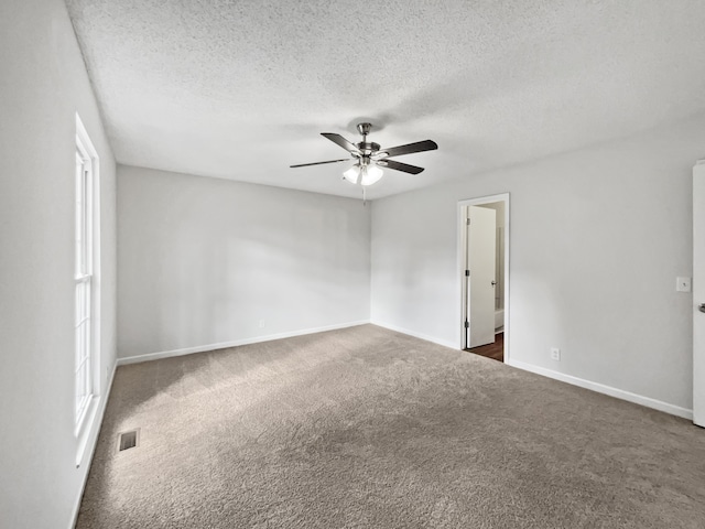 carpeted empty room with a textured ceiling and ceiling fan