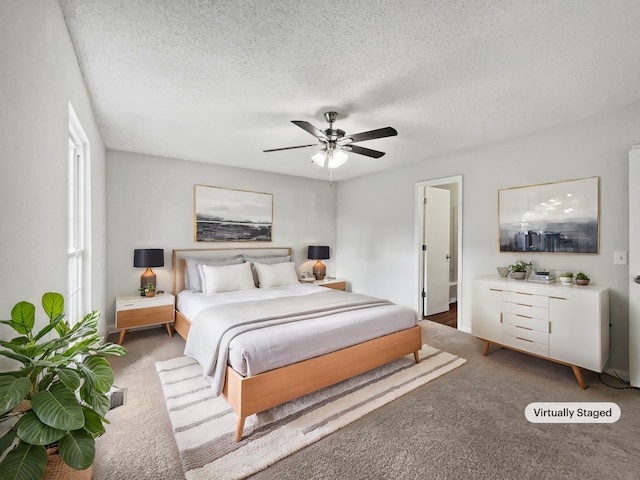 bedroom featuring ceiling fan, carpet floors, and a textured ceiling