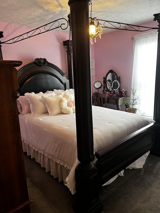 carpeted bedroom with a textured ceiling