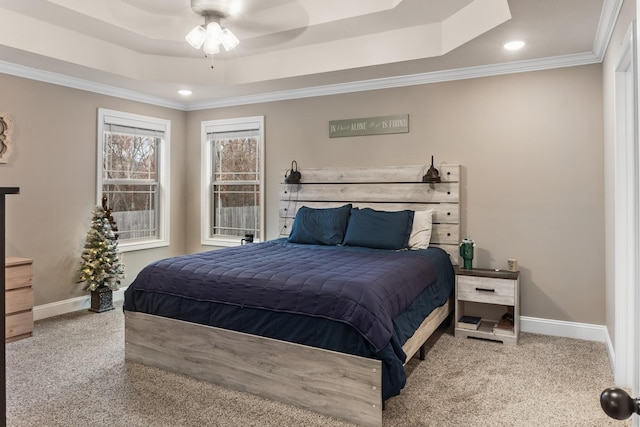 bedroom with crown molding, a raised ceiling, ceiling fan, and carpet flooring