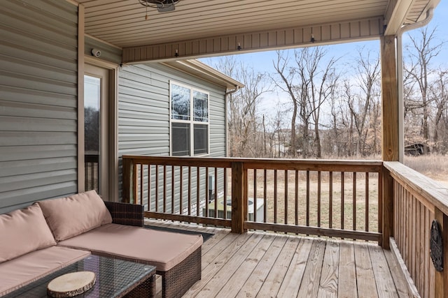 wooden terrace featuring an outdoor hangout area and ceiling fan