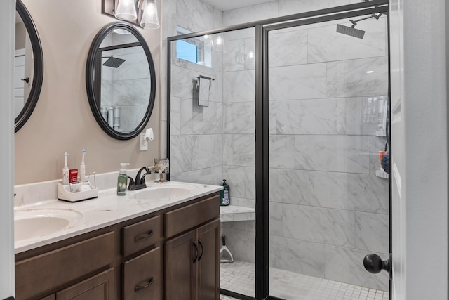 bathroom with vanity and a shower with door