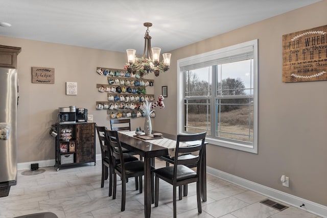 dining space featuring a chandelier