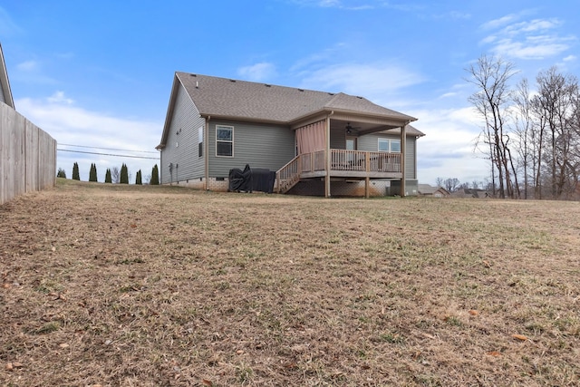 back of house with ceiling fan, a yard, and a deck