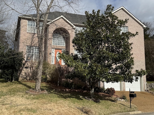 view of front facade with a front yard and a garage