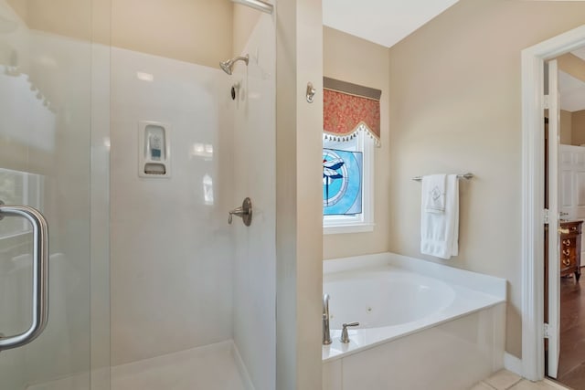 bathroom featuring tile patterned flooring and independent shower and bath