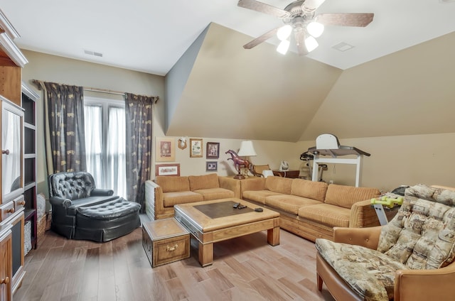 living room featuring ceiling fan, light hardwood / wood-style floors, and lofted ceiling