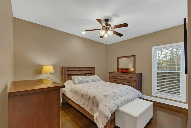 bedroom with ceiling fan and dark wood-type flooring