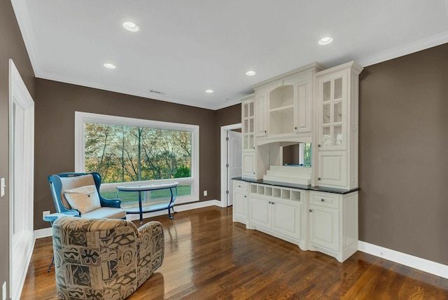 sitting room with crown molding and dark hardwood / wood-style flooring