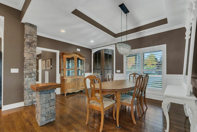 dining room with decorative columns, ornamental molding, dark hardwood / wood-style floors, and a notable chandelier