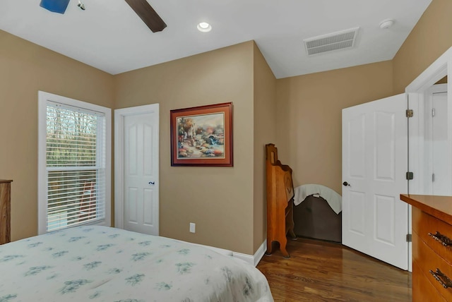 bedroom with ceiling fan and dark wood-type flooring