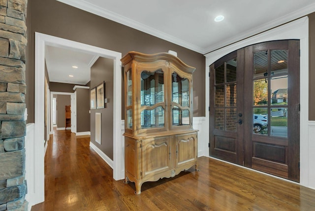 foyer with french doors, dark hardwood / wood-style floors, and ornamental molding