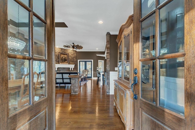 foyer featuring ceiling fan with notable chandelier, dark hardwood / wood-style floors, and ornamental molding